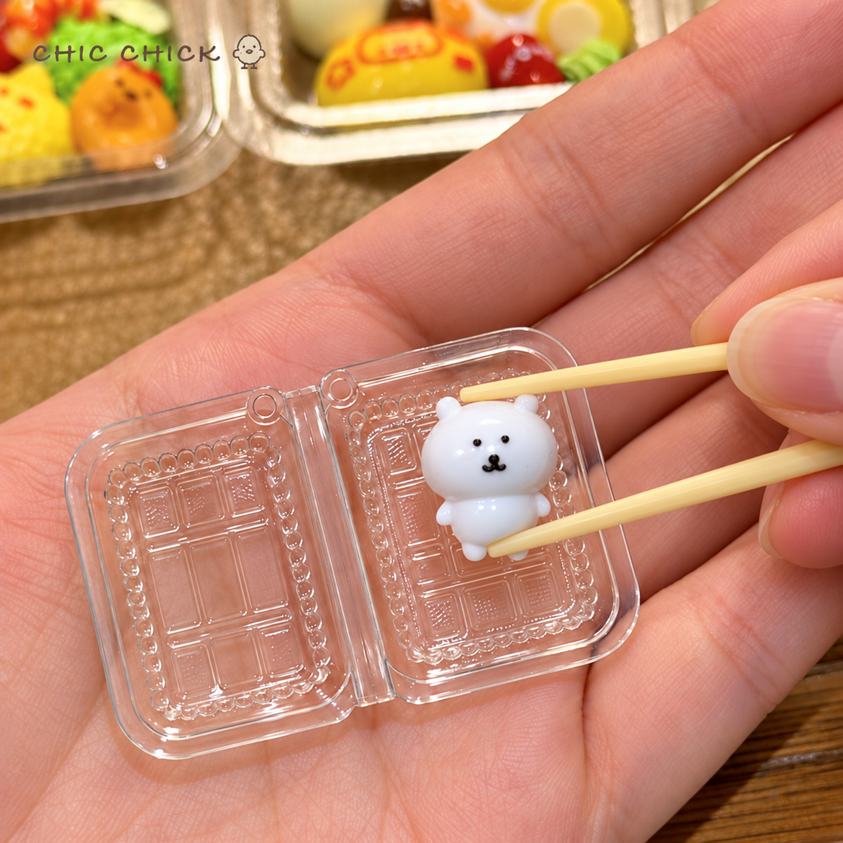 Tiny Bear Bento Squishy Charm lifted from its clear box