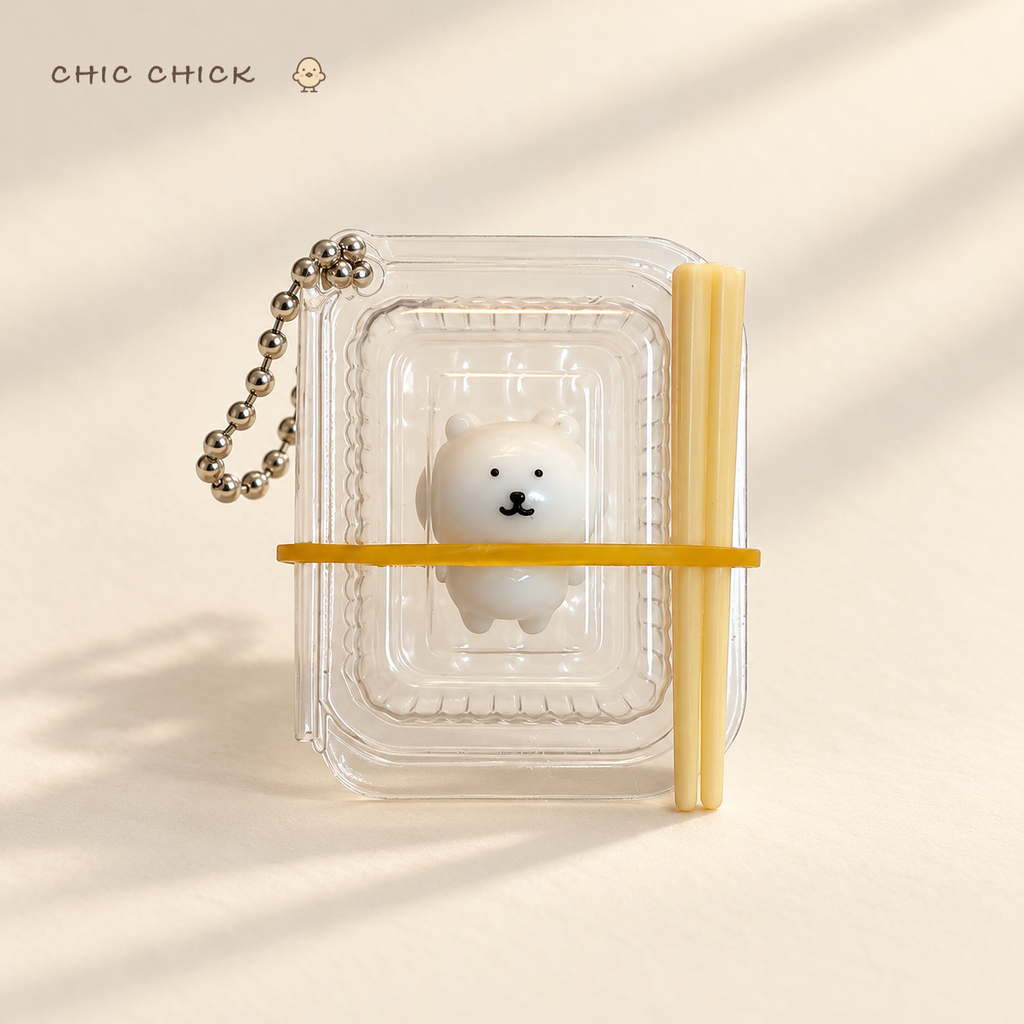 Tiny Bear Bento Squishy Charm in its clear mini bento box