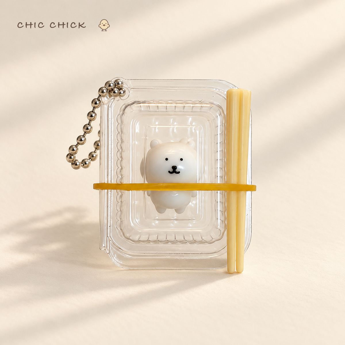 Tiny Bear Bento Squishy Charm in its clear mini bento box
